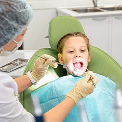 Dentist examining child's teeth